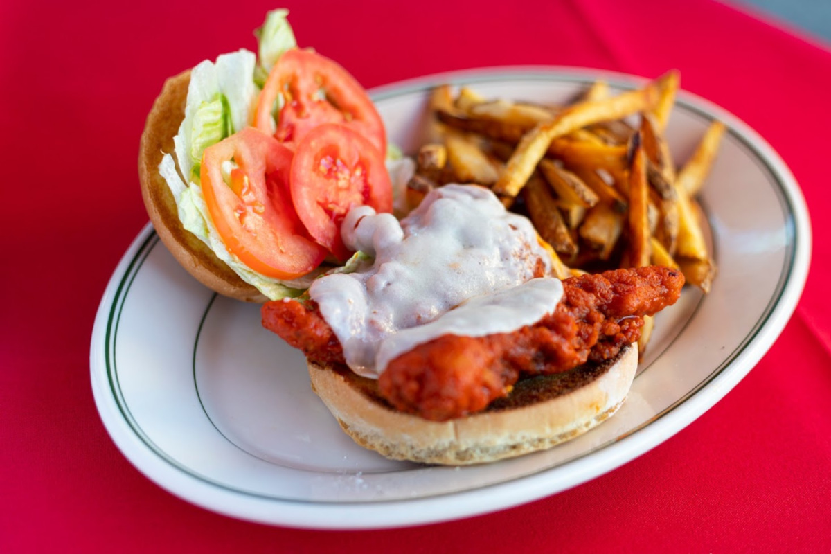 Burger with meat and salad, fries on the side